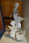 A Lladro figure (af) and another figure of doves.