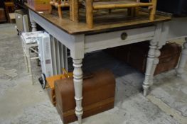 An oak kitchen table with painted base.