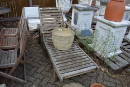 A large hardwood garden lounger.