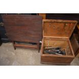 A small pine box containing tools together with a folding table.