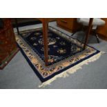 A Chinese rug, blue ground with floral decoration 180cm x 125cm.