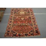 A Persian carpet with all over stylised decoration 280cm x 206cm.