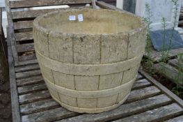 A large reconstituted stone garden planter.