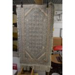 An ethnic tapestry style rug 195cm x 102cm.