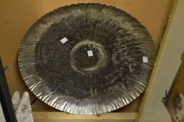 A large beaten metal dish.