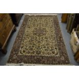 A Persian rug, beige ground with all over floral decoration 225cm x 140cm.