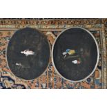 A pair of oval paintings on fabric, unframed.