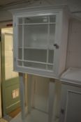 A white painted cabinet on stand.