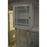 A white painted cabinet on stand.