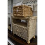 A wicker storage basket and similar stand with cupboard.