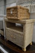 A wicker storage basket and similar stand with cupboard.