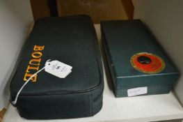 A cased set of Boule and a boxed carpet bowls game.