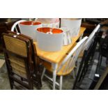 A hardwood rectangular kitchen table with painted base together with four matching chairs.