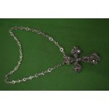 An ornate crucifix on a chain.