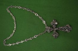 An ornate crucifix on a chain.