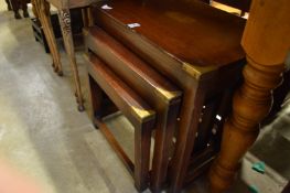A nest of brass bound mahogany tables.