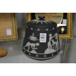An unusual Wedgwood black jasperware jar and cover made especially for W T Lamb and Sons (lid