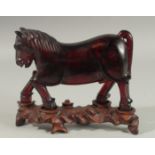 A RARE CHINESE BAKELITE -POSSIBLY CHERRY AMBER HORSE on original wooden stand, horse 21cm long,