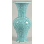 A CHINESE POWDER BLUE GLAZE PORCELAIN VASE, with carved floral motifs and bats, 25.5cm high.