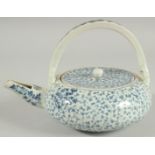 A JAPANESE BLUE AND WHITE PORCELAIN TEAPOT, with foliate decoration.
