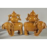 A PAIR OF CHINESE YELLOW GLAZE POTTERY ELEPHANTS, each approx. 22cm long.