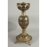 AN UNUSUAL MIXED METAL ENAMELLED BRASS LAMP, with central brass overlaid coconut, the circular