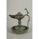 A 13TH CENTURY PERSIAN SELJUK KHURASAN BRONZE OIL LAMP, 19cm high.