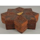 A FINE 19TH CENTURY PERSIAN QAJAR ABADEH CARVED WOOD STAR-SHAPE BOX, the lid with carved and pierced