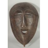 A LARGE AFRICAN TRIBAL CARVED WOOD MASK, 38cm x 25cm.