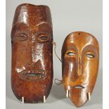 TWO AFRICAN CARVED WOOD MASKS, 21cm x 9.5cm and 16.5cm x 9cm.