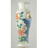 A CHINESE WUCAI PORCELAIN BALUSTER VASE, painted with an exotic bird on a rocky mound and native