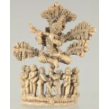 A FINE 17TH-18TH CENTURY SOUTH INDIAN CARVED BONE FLUTING KRISHNA UNDER TREE, 10.5cm high.