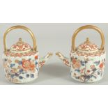 A FINE PAIR OF IMARI PORCELAIN TEAPOTS, painted in the typical Imari palette with blue,