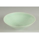 A CHINESE CELADON BOWL, with incised decoration, 20.5cm diameter.