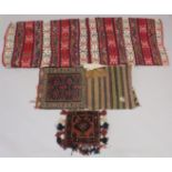 THREE PERSIAN SADDLE BAGS AND RUGS.