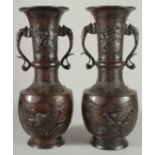 A LARGE PAIR OF JAPANESE BRONZE TWIN HANDLE VASES, with relief decoration depicting birds on