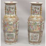 AN IMPRESSIVE PAIR OF CHINESE CANTON FAMILLE ROSE PORCELAIN FLOOR-STANDING VASES, beautifully