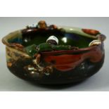 A JAPANESE SUMIDA POTTERY BOWL, with two partly glazed figures to either side of the bowl, signed to