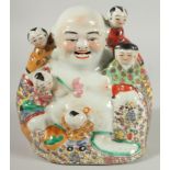 A CHINESE PORCELAIN HAPPY BUDDHA with surrounding children, impressed mark to base, 21cm high.