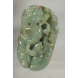 A CHINESE CARVED JADE PEBBLE, depicting a dragon, 7.5cm x 4.5cm.