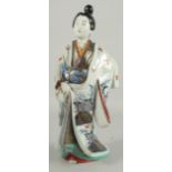 A FINE AND LARGE JAPANESE ARITA PORCELAIN BIJIN, the robe painted with blue and white patterns and