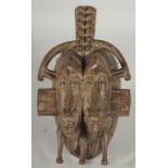 AN AFRICAN TRIBAL DOUBLE-HEADED CHILD MASK, 27cm x 16cm.