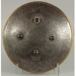 AN ISLAMIC ENGRAVED STEEL SHIELD, with four raised bosses, engraved with foliate panels containing