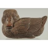 A CHINESE CARVED WOOD FIGURE OF A DUCK, with inset bone character mark, 9cm long.