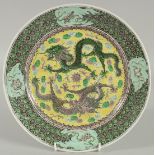A CHINESE FAMILLE VERTE PORCELAIN PLATE, finely painted with two dragons and stylised clouds on a