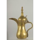 A STAMPED ISLAMIC BRASS COFFEE POT, 27cm high.