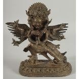 A TIBETAN BRONZE FIGURE OF A THREE-HEADED DEITY, 24.5cm high.