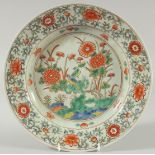 AN EARLY 20TH CENTURY CHINESE EXPORT WUCAI PORCELAIN DISH, painted with bird and native flora, 29.