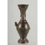 A SMALL BRONZE TWIN HANDLE VASE, with relief dragon, 16.5cm high.
