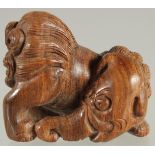 A CHINESE CARVED WOOD NETSUKE OF A BEAST, 4cm wide.